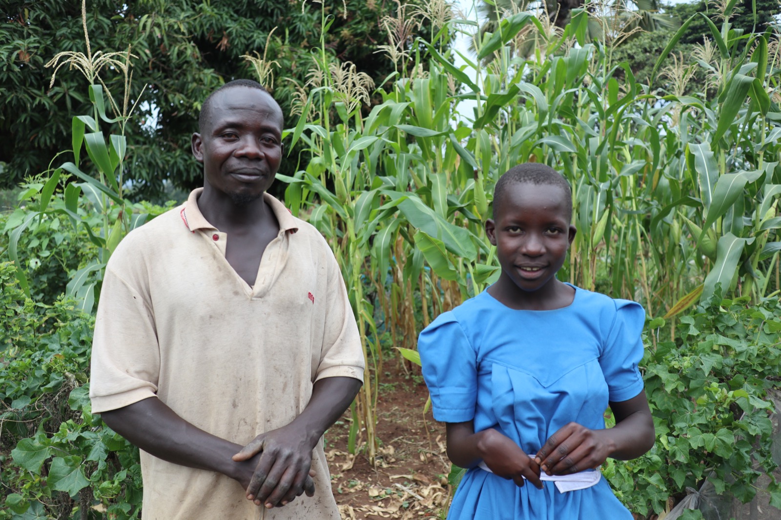 A picture of Godwin (37) with one of his oldest child, Maria, who has a disability but still does many chores around the house.